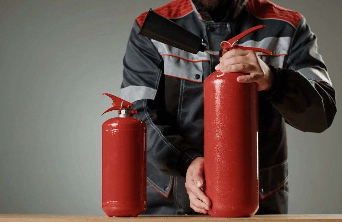 Master Fire Prevention Systems NYC Man Displaying Fire Extinguishers 1